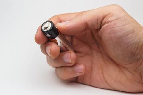 Hand with one battery Foto stock