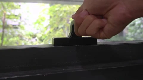 Hand open and lock black door handle window glass at office outdoor day Stock Footage 251512805