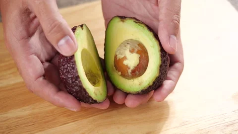 Hand open avocado fruit in slow motion Stock-Footage 139730855