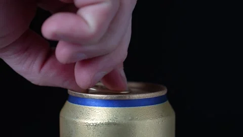 Hand open a can of beer, black background, close-up Video stock 251640608