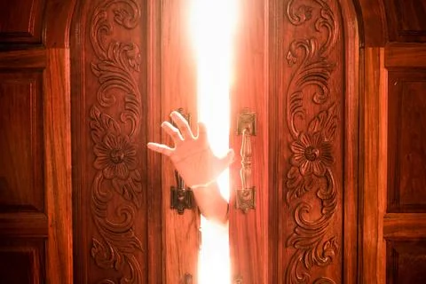 Hand open door light Stock Photos