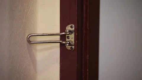 Hand open The Door With A Security Lock Stock Footage 312077696