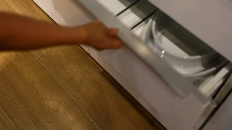 The hand open drawer to pick up ceramic bowl out and keep ceramic bowl into b Stock Footage 79429949
