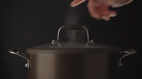 Hand open lid on steaming pot Stock Footage 61802372