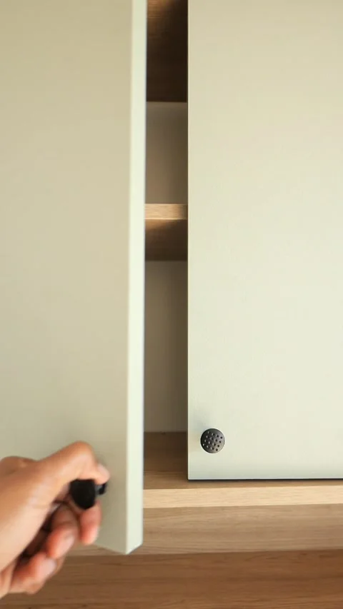 Hand open a modern kitchen cabinet doors with decorative knobs 스톡 동영상 307668593
