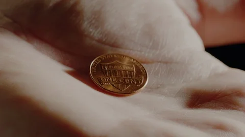 Hand open with penny and close around penny in extreme closeup. Stock Footage 101626208