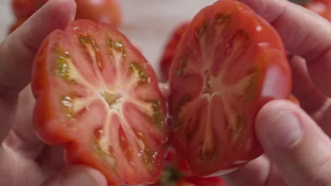 HAND OPEN A TOMATO IN HALF Stock Footage 132635681