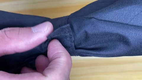 Hand open velcro strap from umbrella. Close up Stock Footage 249788466