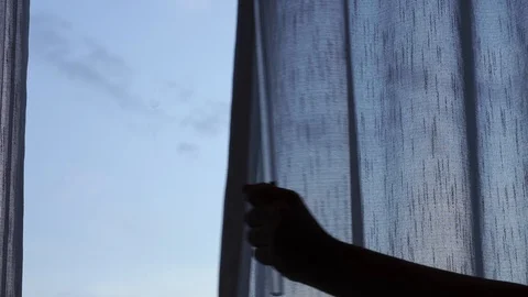 Hand open window curtain to right of frame Stock Footage 120765739