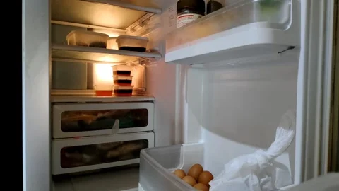 A hand opened the refrigerator door, revealing the interior shelves Video stock 305164886