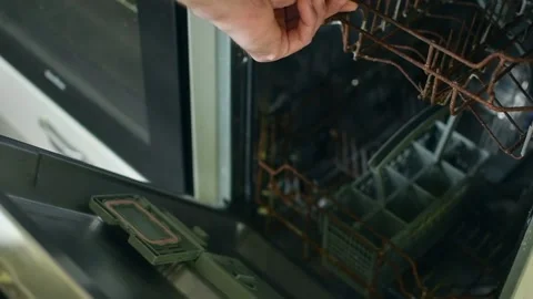 Hand opening and closing dishwasher, showing severely rusty interior basket, 動画素材 310563637
