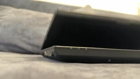 Hand opening and closing laptop screen on sofa, portable computer daily use and Stock Footage 337121465
