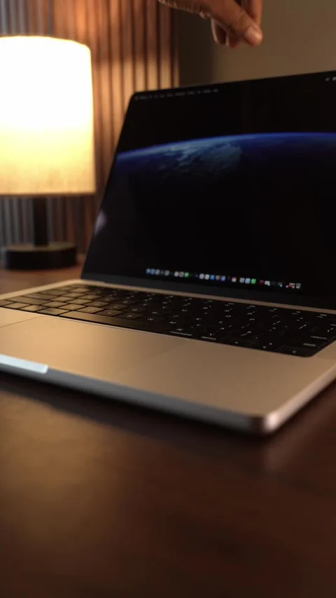 Hand Opening and Closing MacBook Lid in Warm Lighted Room Stock Footage 340968013