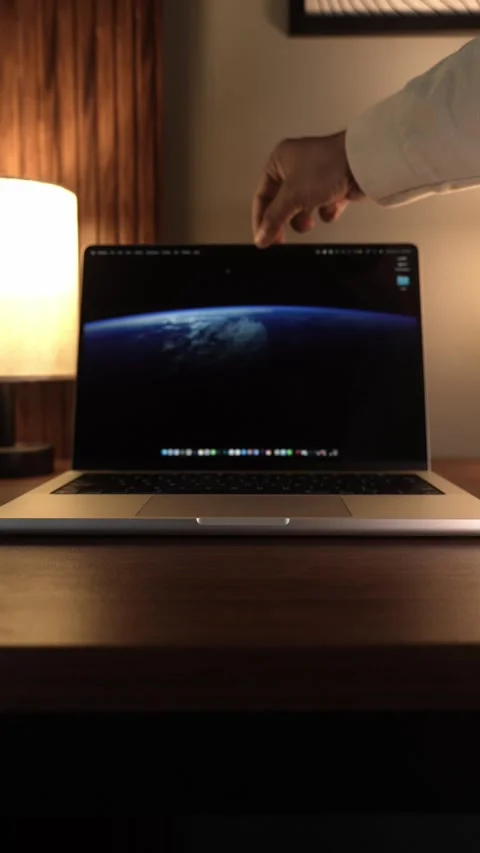 Hand Opening and Closing MacBook Lid in Warm Lighted Room Stock Footage 340968027