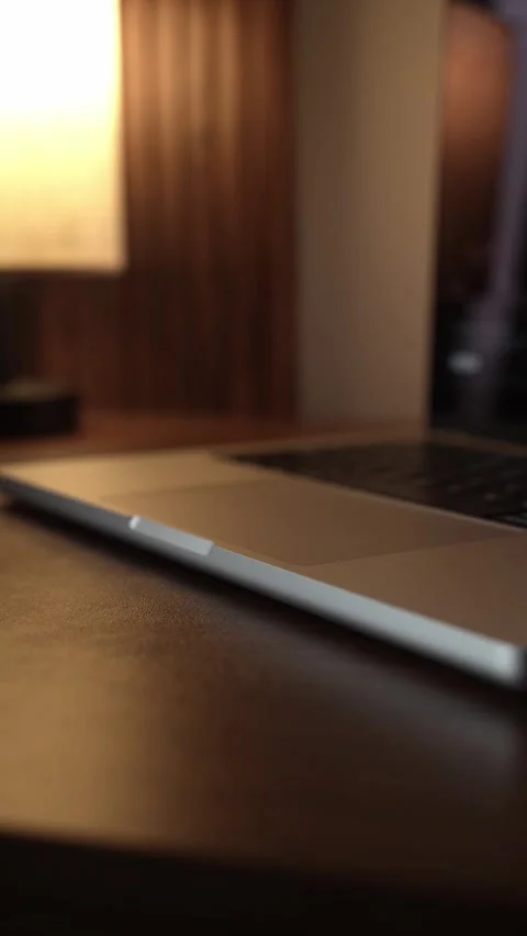 Hand Opening and Closing MacBook Lid in Warm Lighted Room Stock Footage 340968071