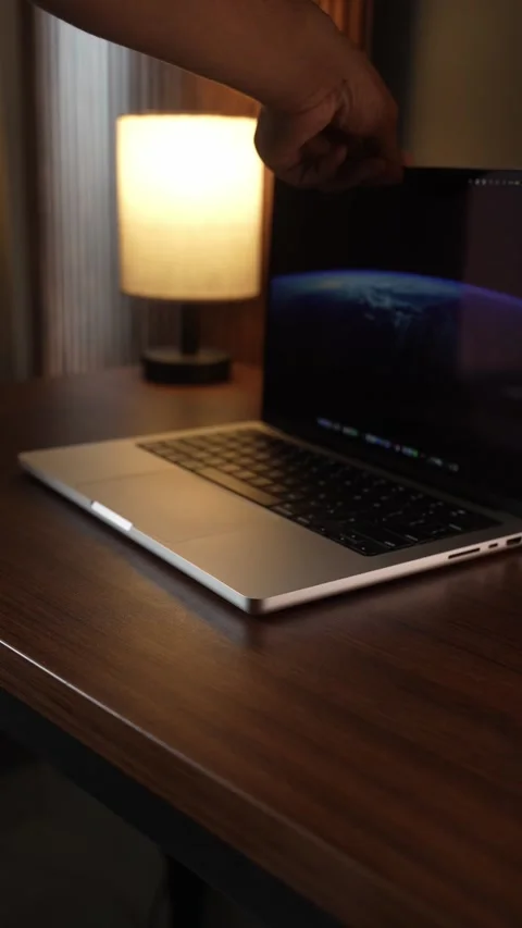 Hand Opening and Closing MacBook Lid in Warm Lighted Room Stock Footage 340968110
