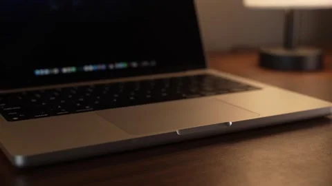 Hand Opening and Closing MacBook Lid in Warm Lighted Room Stock Footage 340968159
