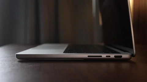 Hand Opening and Closing MacBook Lid in Warm Lighted Room Stock Footage 340968217