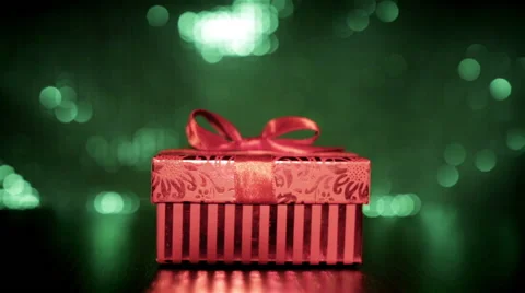 Hand opening and presenting red gift box on green background Stock Footage 52182364