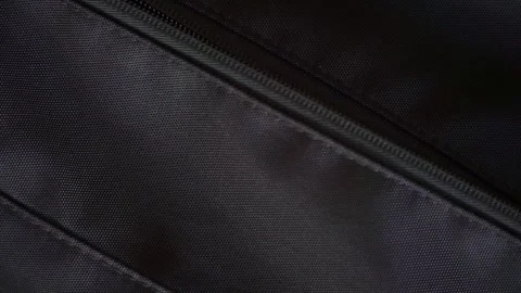A hand opening a backpack zipper with a smartphone displaying "My Father 스톡 동영상 336672161