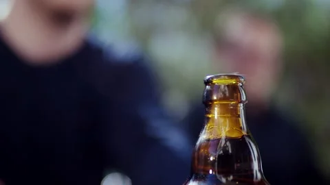 Hand Opening a Beer Bottle with Keychain Opener, Outdoor Close Up Shot Vídeo Stock 341442585
