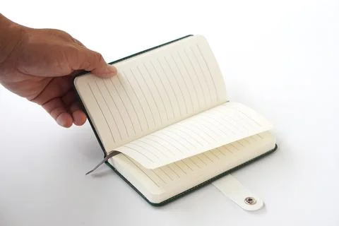 A hand opening a blank lined notebook on white background. Concept for planning, Stock Photos