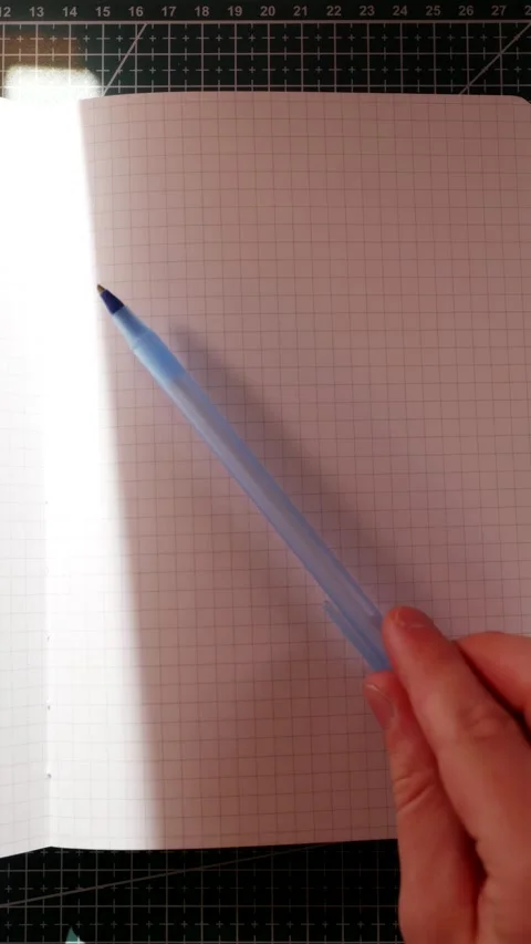 Hand opening blank notebook to start writing vertical Stock Footage 340139056
