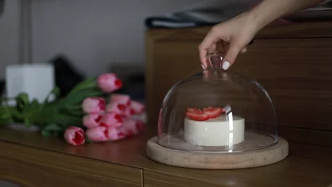 Hand opening a cake under a glass Stock Footage 235558689