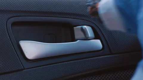 Hand opening car door handle: closeup sequence in motion Stock Footage 313459996