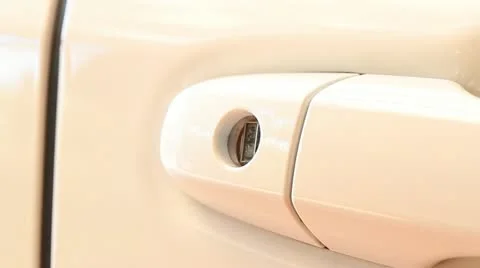 A hand opening a car door with a key Stock Footage 21457233