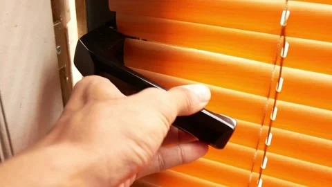 Hand opening the door, close-up, roll curtain door background. Stock-Footage 255003314