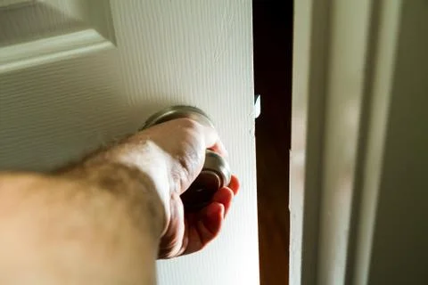 Hand opening a door into the unknown Stock Photos