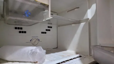 Hand opening empty and dirty old refrigerator freezer door Stock Footage 336705987