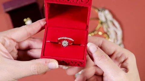Hand opening a Engagement Ring In Red Velvet Box Held During Romantic Proposal Stock Footage 331592206