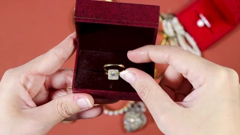Hand opening a Engagement Ring In Red Velvet Box Held During Romantic Proposal Stock Footage 331592213
