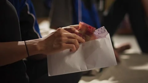 Hand Opening an Envelope to Check Salary Payment Stock Footage 344235915