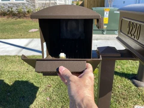 A hand opening a mailbox 스톡 사진