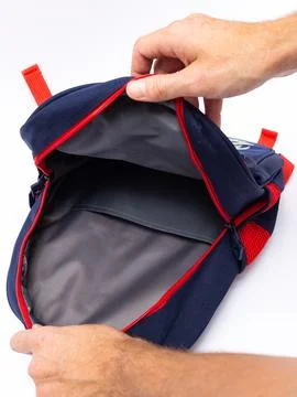 Hand opening navy backpack top compartment Stock Photos