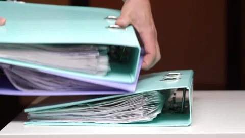 Hand opening a ring binder, organizing and archiving important business Stock Footage 347238764