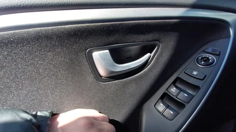 Hand opening silver car door handle from inside Stock Footage 334733549