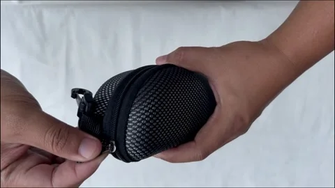 Hand Opening Small Black Zipper Pouch on White Background Stock Footage 320587868