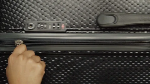 Hand opening a suitcase Stock Footage 128096431