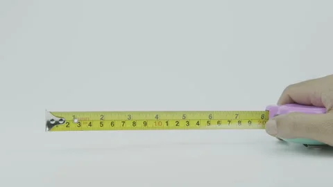 Hand Opening Tape Measure on White Background Stock Footage 292045060