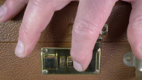 Hand opening a three number combination lock on a case. Video stock 150741070
