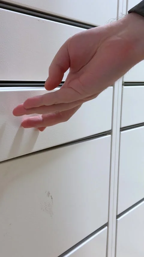 A hand opening a white metal storage locker door to reveal a compartment, Stock Footage 346466552
