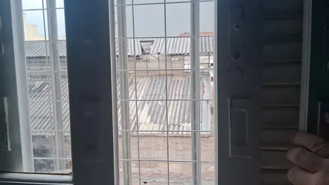 Hand opening white window shutters in this interior motion video footage Stock Footage 339248246