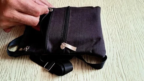 Hand Opening Zipper on Small Dark Fabric Pouch Indoor Detail Video stock 343215860