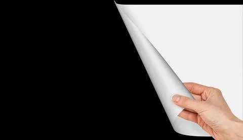 Hand opens a blank paper curl page on black empty background Stock Photos