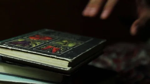 The hand opens the book, in dark Stock Footage 71100599