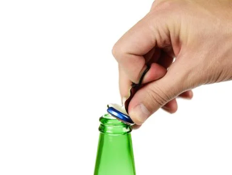 The hand opens a bottle of beer, cap with a ring for opening. Close up. Isola 库存照片